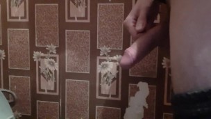 Russian guy with a big dick pees in the toilet