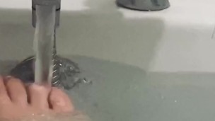 My feet in the bath playing with my rubber duck 