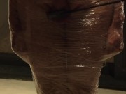 Male slave bound in cling wrap gets riding crop CBT by two gorgeous Femdoms 15/16