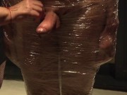 Male slave bound in cling wrap gets riding crop CBT by two gorgeous Femdoms 9/16