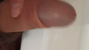 Pees and jerks off in the bathroom. Showing off the dick head.