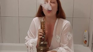 Hot redhead MILF takes a bong hit 