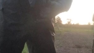 Lad hauls cock and balls out from PVC coveralls to take a piss