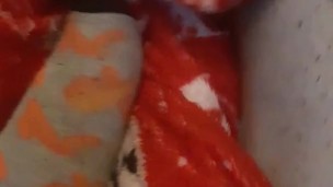 Tiny feet in mix match socks rubbing blanket