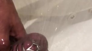 Rock hard cock caged in a shower chastity 