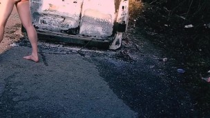Hanging out beside burnt out van 