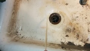 Just a small piss In a dirty sink.