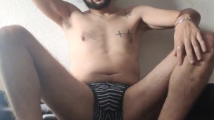 Young man in underwear touching
