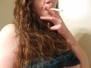 Sexy red head smoking and playing with titties 1/16