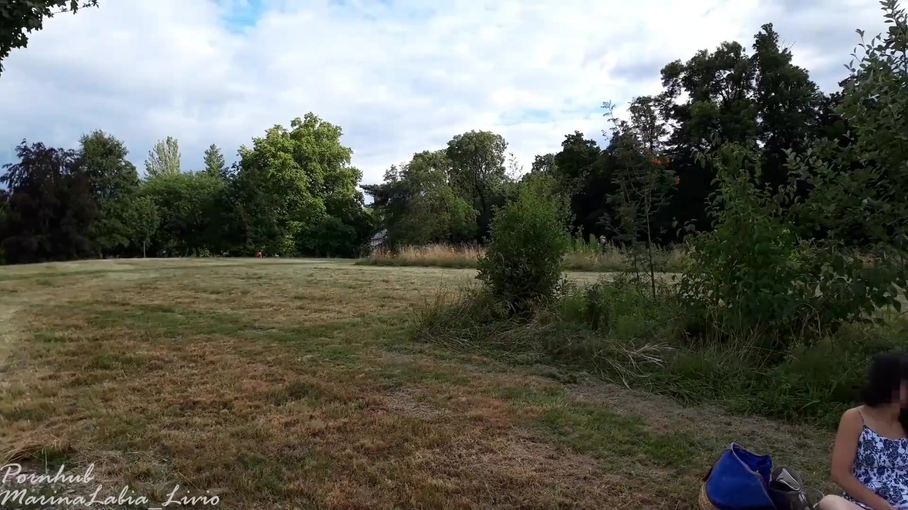 Risky insertion of a large glass sex toy in a public park with people behind the grass - RedTube