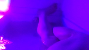 Washing her cheeks in the bath with a blacklight