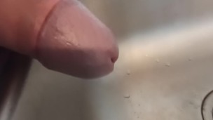 Close up of cock while pissing in the sink