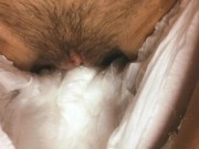 A girl with a hairy pussy pissing in a diaper.  14/16