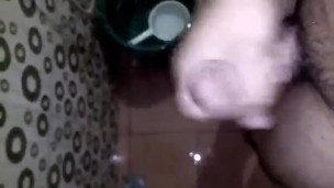 Horny Young Guy Having Fun Jerking Off His Huge Cock in the Toilet