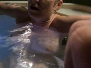 Orgasm in the hot tub playing with her pussy