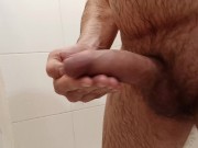 Jerking off gently in the bathroom. Saliva on the dickhead.