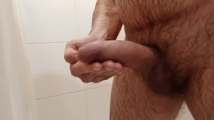 Jerking off gently in the bathroom. Saliva on the dickhead.