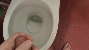 The guy pisses in the toilet for a long time