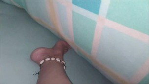 PLAYING UNDER THE SHEETS. GIRL TOUCHES HER WET PUSSY