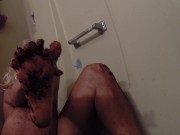 SparklePussPH sits in a bathtub and massages her feet with coffee grounds