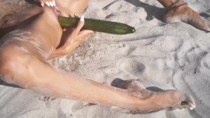 Tight Pussy takes a Hot Golden Shower while being Penetrated by a Cucumber on the Beach