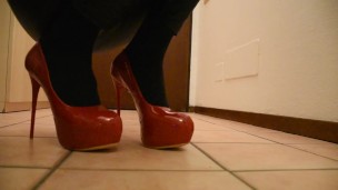Fuchsia Doll walking in red high heels