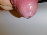 Uncircumcised hard cock plays with foreskin and pre-cum close-up, hard micropenis