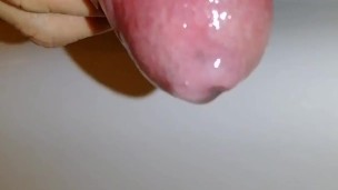 Uncircumcised hard cock plays with foreskin and pre-cum close-up, hard micropenis