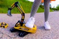 Big excavator is destroyed kicked, trampled, crushed, smashed, crushed, broken plastic car, crush