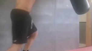 Boxing the heavy bag. Real-life bad boy and straight porn actor working out.