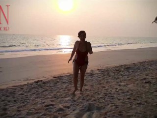 Nice lady at lonely nudist beach. Red swimsuit. Red bikini. Coconut