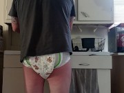 Baby wets diaper while washing dishes