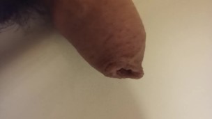Extreme closeup pissing uncutted cock.