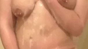 Milf seductively showers and plays with large, pierced breasts and horny, pierced pussy