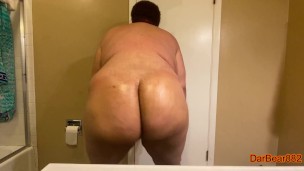 Fat man oiling up his fat ass then shaking it