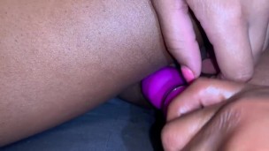 Ebony teen plays with clit and vibrator from the back