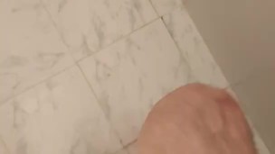 Boy showers in speedo swimsuit and soaps his feet