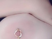 Redhead teases her pierced tits