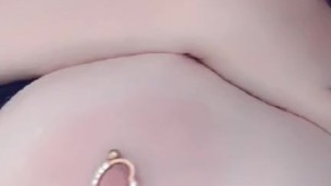 Redhead teases her pierced tits