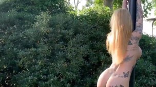 Outdoors, blonde girl dancing and musturbing in a public park