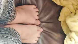 Hot little feet stepping on leather couch 