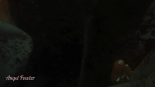Girl Peeing in darkness into tropical river after sunset - Angel Fowler 
