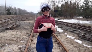 Girl undresses on the train tracks