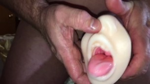 Tongue out Stroker Toy pleasing my cock gets a load of Cum that we swap & cum kiss