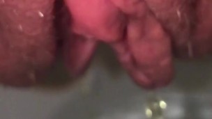 Upclose and slow motion of swollen red pussy pissing immediately after sex