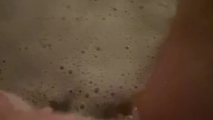 Horny babe plays with her wet pussy in the bath