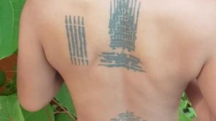 Slave May is showing her tattoos next to the swimming pool