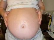 Pregnant milf strips and massages herself with lotion