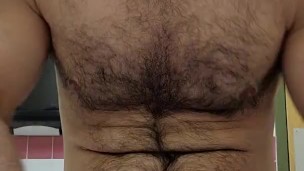 Muscle bear flexing in red boxer breifs 