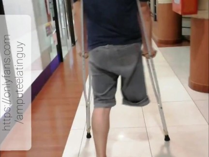 Amputee guy walking with crutches